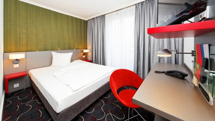 Die roten Farbakzente in den Zimmern erinnern an die Hotelmarke Ibis. Bild: Success Hotel Group