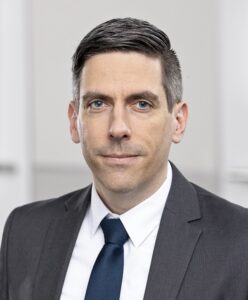 Dunkelhaariger Mann mit Anzug und Krawatte