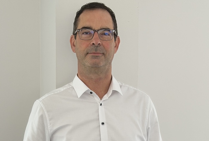 Mann mit dunklem Haar und weißem Hemd